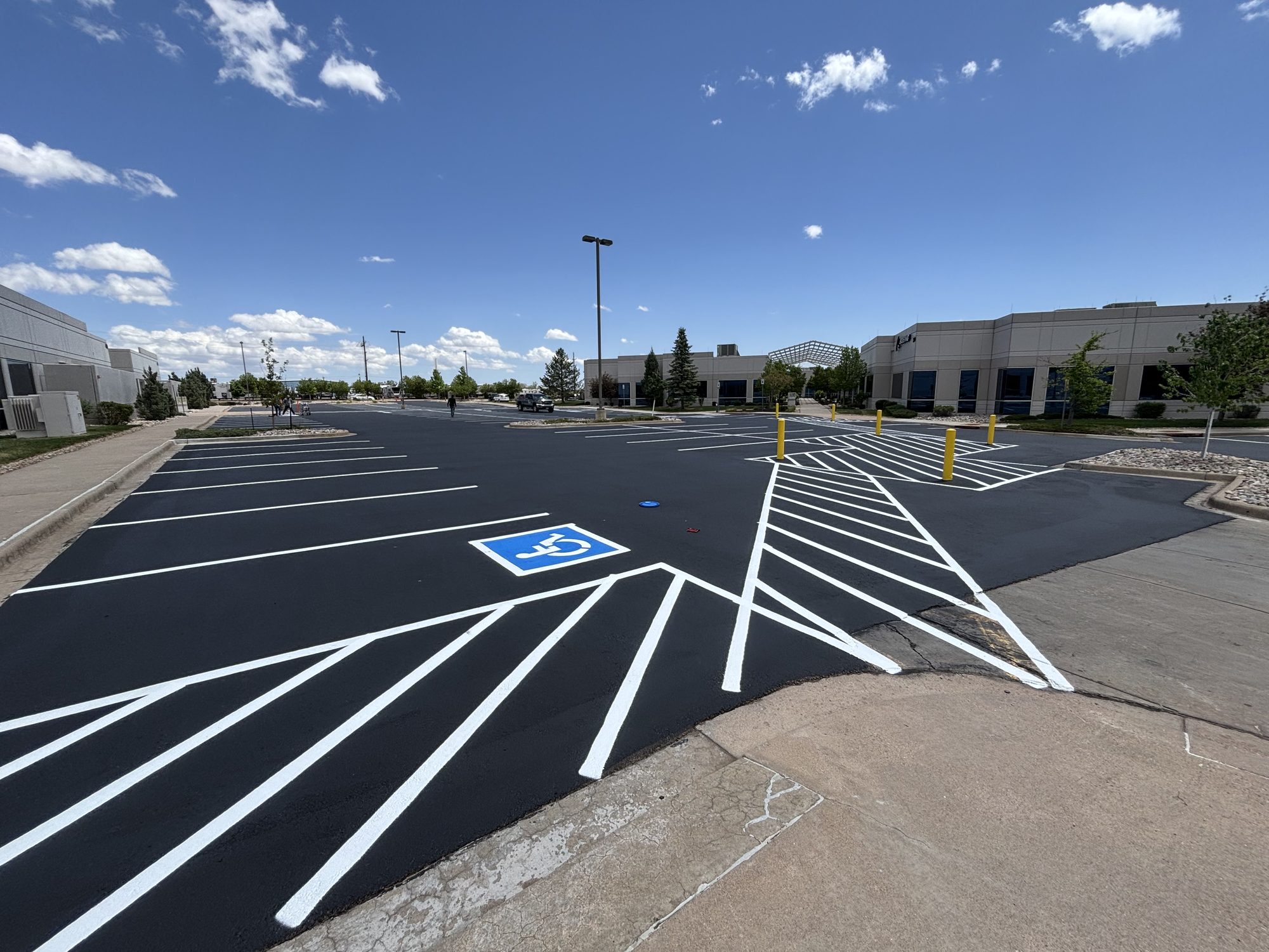 Freshly seal coated parking lot with new striping and ADA markings